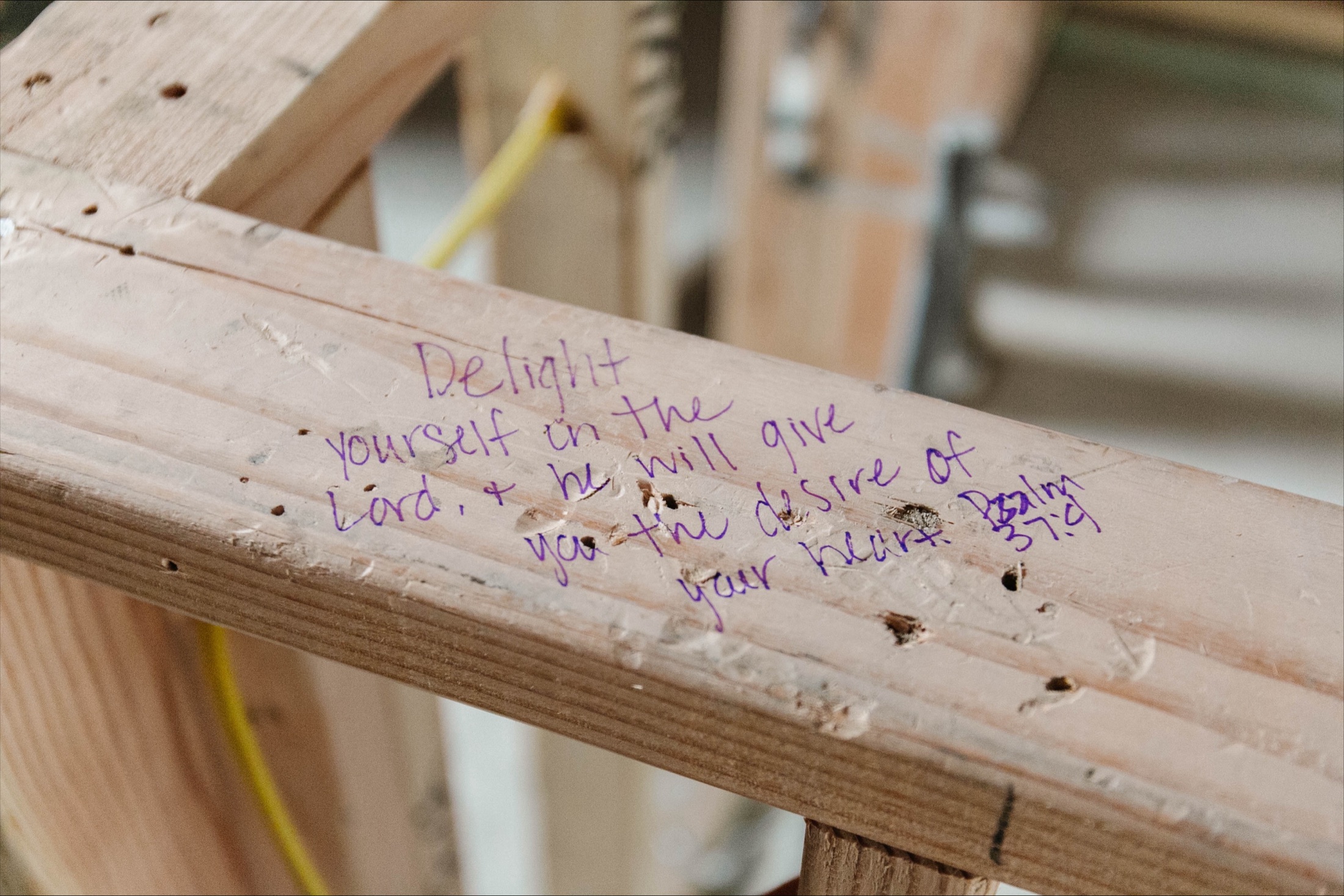 A blessing written in marker on the framing of a house under construction