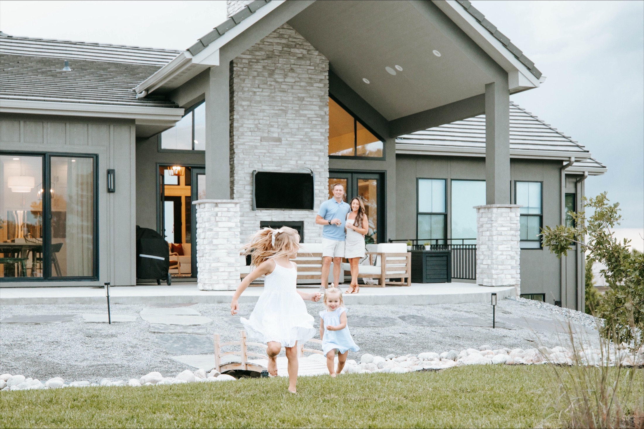 A family together outside their finished custom home